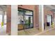 Glass entrance to the building, surrounded by brick columns, with concrete sidewalk at 112 Rogers St # 409, Atlanta, GA 30317
