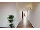 Long hallway with wood floors, white walls, and modern light fixtures, with plant at 112 Rogers St # 409, Atlanta, GA 30317