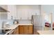 Well-lit kitchen with sleek white cabinets, stainless steel appliances, and hardwood floors at 112 Rogers St # 409, Atlanta, GA 30317