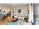 Bright living room featuring a modern sofa, colorful rug, and a sliding door to the outside at 112 Rogers St # 409, Atlanta, GA 30317
