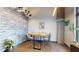 Conference room featuring a wooden table with chairs, decorative plants, and brick accent wall at 112 Rogers St # 409, Atlanta, GA 30317