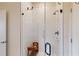 Walk-in shower with white tiling, glass door, and a built-in bench at 112 Rogers St # 409, Atlanta, GA 30317