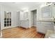 Bright and spacious bathroom featuring dual vanities, wood flooring, and access to a walk-in closet at 1265 Oldfield Rd, Decatur, GA 30030