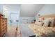 Comfortable bedroom with a sloped ceiling, dormer window, and neutral color scheme at 1265 Oldfield Rd, Decatur, GA 30030