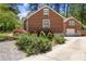 Charming brick home with a well-maintained driveway and professionally landscaped yard at 1265 Oldfield Rd, Decatur, GA 30030