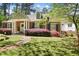 Charming brick home featuring a well-manicured lawn, colorful landscaping, and a welcoming front entrance at 1265 Oldfield Rd, Decatur, GA 30030
