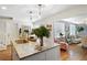 Open-concept kitchen featuring a granite island with pendant lighting and views of the adjacent living area at 1265 Oldfield Rd, Decatur, GA 30030