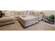 Spacious living room with neutral sectional sofa, ottoman, and plush carpeting at 1265 Oldfield Rd, Decatur, GA 30030