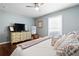 Tranquil bedroom with hardwood floors, a stylish dresser, and a large window creating a peaceful retreat at 1265 Oldfield Rd, Decatur, GA 30030