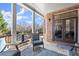 Relaxing covered back porch with comfortable seating, outdoor views, and brick accent wall at 2046 Chambord Way, Snellville, GA 30078