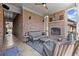 Covered back porch featuring an outdoor fireplace, comfortable seating, and brick walls at 2046 Chambord Way, Snellville, GA 30078