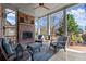This covered back porch offers an outdoor fireplace, comfortable seating, and a view of the backyard at 2046 Chambord Way, Snellville, GA 30078