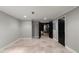 Spacious basement featuring tile flooring, neutral paint, and black doors at 2046 Chambord Way, Snellville, GA 30078