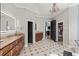 Spacious bathroom features double vanity, decorative chandelier, and opens to walk-in closet at 2046 Chambord Way, Snellville, GA 30078