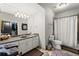 Bathroom featuring a double vanity, a walk-in shower, and a door to a walk-in closet at 2046 Chambord Way, Snellville, GA 30078