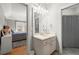This bathroom features a vanity with a marble countertop and a sink, and leads to the bedroom and toilet at 2046 Chambord Way, Snellville, GA 30078