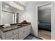 Bathroom featuring a double vanity, a walk-in shower, and a view into another bedroom at 2046 Chambord Way, Snellville, GA 30078