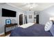 Bedroom with light blue walls, hardwood floors, ceiling fan and ensuite bathroom access at 2046 Chambord Way, Snellville, GA 30078