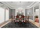 Elegant dining room featuring a crystal chandelier, stylish decor, and ample natural light at 2046 Chambord Way, Snellville, GA 30078