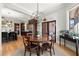 Open-concept dining room features a round wood table, unique light fixture, and access to outdoor space at 2046 Chambord Way, Snellville, GA 30078