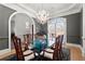 Elegant dining room with a glass table, chandelier, and views from the window at 2046 Chambord Way, Snellville, GA 30078