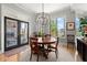 This dining room has a stylish light fixture and lots of natural light from large windows at 2046 Chambord Way, Snellville, GA 30078