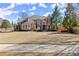 A well-maintained brick house features a lush green lawn and mature trees at 2046 Chambord Way, Snellville, GA 30078