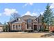 Beautiful brick home with a well-manicured lawn and mature trees, perfect for a Gathering at 2046 Chambord Way, Snellville, GA 30078