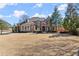A well-maintained brick house features a lush green lawn and mature trees at 2046 Chambord Way, Snellville, GA 30078