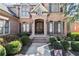 Inviting entryway with brick steps, lush shrubbery, and elegant double doors at 2046 Chambord Way, Snellville, GA 30078