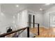 Upstairs hallway features beautiful hardwood floors, glass railing, and lots of natural light at 2046 Chambord Way, Snellville, GA 30078