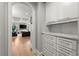 Hallway with storage cabinets leading to a living room with coffered ceiling at 2046 Chambord Way, Snellville, GA 30078