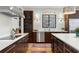 Bright kitchen with stainless steel appliances, white countertops, and dark wood cabinets at 2046 Chambord Way, Snellville, GA 30078