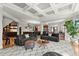 Open concept living area with views of the kitchen, featuring coffered ceilings and modern furnishings at 2046 Chambord Way, Snellville, GA 30078