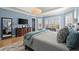 Bright main bedroom featuring a large dresser, hardwood floors with a fluffy rug, and windows with shutters at 2046 Chambord Way, Snellville, GA 30078