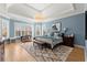 Expansive main bedroom with tray ceiling, a bay window area, and a light-colored rug over hardwood floors at 2046 Chambord Way, Snellville, GA 30078