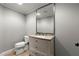 Bathroom featuring a vanity with drawers, a large mirror, and a toilet at 2046 Chambord Way, Snellville, GA 30078