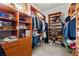 Spacious walk-in closet with custom wood shelving, hanging rods, and organization at 2046 Chambord Way, Snellville, GA 30078