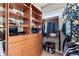 Organized walk-in closet featuring wooden shelves, hanging clothes, and overhead storage space at 2046 Chambord Way, Snellville, GA 30078