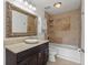 Bathroom with a framed mirror over the vanity, decorative tiling in the shower/tub, and modern fixtures at 6 Walnut Hill Nw Pl, Atlanta, GA 30318