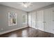 Cozy bedroom featuring hardwood floors, ample closet space, and natural light at 6 Walnut Hill Nw Pl, Atlanta, GA 30318