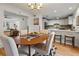 Open dining area with hardwood floors, a table setting, and a breakfast bar at 6 Walnut Hill Nw Pl, Atlanta, GA 30318