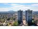 Aerial view of the building exterior highlighting the downtown area and green lush trees at 2575 Peachtree Ne Rd # 8D, Atlanta, GA 30305
