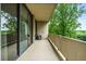 Private balcony with a seating area overlooking lush landscaping, and sliding glass doors at 2575 Peachtree Ne Rd # 8D, Atlanta, GA 30305