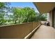 Private balcony featuring a concrete railing and an outdoor chair overlooking lush green trees at 2575 Peachtree Ne Rd # 8D, Atlanta, GA 30305