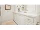 Bright bathroom featuring double sinks, white cabinets, and a marble countertop at 2575 Peachtree Ne Rd # 8D, Atlanta, GA 30305