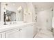 Bright bathroom features double sinks, white cabinets, and a glass shower at 2575 Peachtree Ne Rd # 8D, Atlanta, GA 30305