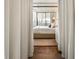 Inviting bedroom with a four-poster bed and neutral décor seen from behind white curtains at 2575 Peachtree Ne Rd # 8D, Atlanta, GA 30305