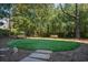 Outdoor dog park area with benches and artificial turf, surrounded by trees and lush landscaping at 2575 Peachtree Ne Rd # 8D, Atlanta, GA 30305