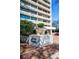 Exterior of Plaza Towers featuring lush landscaping, street signage, and ample parking at 2575 Peachtree Ne Rd # 8D, Atlanta, GA 30305